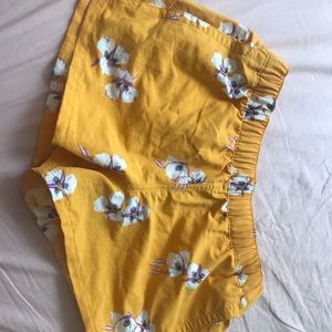 yellow patagonia shorts with a flower design